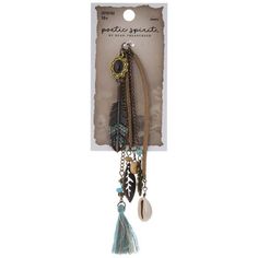 a key chain with feathers and beads hanging from it's front end in a package