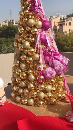 a christmas tree made out of gold and pink ornaments