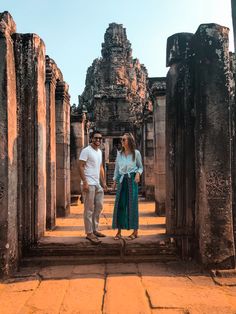 a man and woman standing in an ancient temple