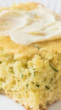 a close up of a piece of cake with icing on it and a fork