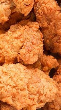 fried chicken is piled up in a pile