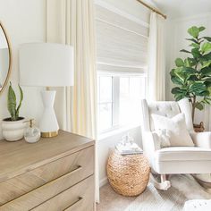 a living room filled with furniture and a large mirror on the wall next to a window