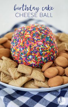 birthday cake cheese ball on a plate with sprinkles and crackers around it