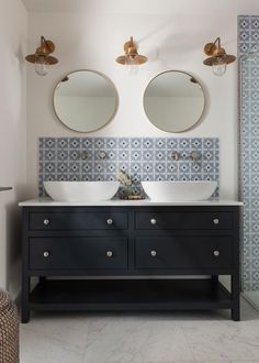 a bathroom with two sinks and mirrors on the wall