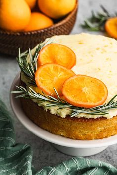 a cake with orange slices and rosemary on top