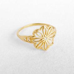 "A unique gold flower statement ring with a delicate clear or black diamond. Handcrafted craftmenship at it's best - 100% Top quality Gold, 100% handcrafted for each and every customer. Maya Mor Jewelry is dedicated to contemporary and avant-garde jewelry and to one-of-a-kind pieces that are personally designed and created by Maya. The jewels are handmade with skillful goldsmithing work and advanced technologies, comfortable to wear due to their ergonomic shapes and carefully finished with the p Flower Shaped Yellow Gold Diamond Ring As A Gift, Gold Diamond Flower Promise Ring, Gold Diamond Flower Ring For Promise, Gold Flower-shaped Promise Ring, Gold Flower Shape Promise Ring, Gold Flower-shaped Ring For Gift, Gold Flower-shaped Diamond Ring, Gold Flower Shaped Ring For Gift, Gold Diamond Flower-shaped Ring