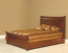 a wooden bed sitting in a bedroom on top of a carpeted floor next to a wall