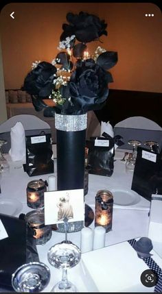 there is a vase with flowers and candles on the table at this wedding reception,