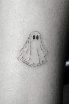 a small ghost tattoo on the leg