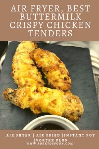 two fried chicken tenders sitting on top of a cutting board