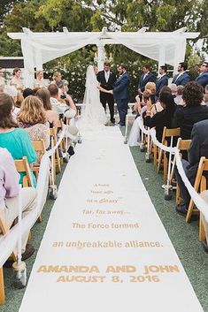 a wedding ceremony with the bride and groom walking down the aisle