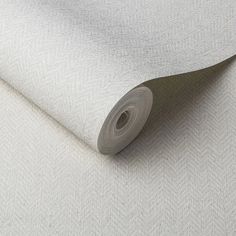 a roll of white fabric on top of a table