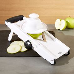 an apple slicer sitting on top of a cutting board