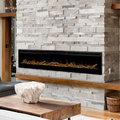 a living room with a large stone fireplace