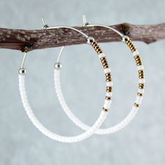 White beaded hoop earrings. ‣ stylish ombre design at the front of the hoops ‣ tiny, Japanese glass seed beads in matte white and metallic bronze ‣ shiny stainless steel beads ‣ carefully handmade, polished earring hoops, made of 316L stainless steel SIZE Approx. diameter: 42 mm / 1.6" Very lightweight, dainty hoops, comfortable to wear. Click here for more beaded hoop earrings: www.etsy.com/shop/LianuDesign?ref=seller-platform-mcnav%C2%A7ion_id%C2%A7ion_id§ion_id=26956662 Or check out all items Cheap White Beaded Hoop Earrings, Cheap White Bohemian Hoop Earrings, Luxury White Hoop Earrings With Ear Wire, Luxury Handmade White Hoop Earrings, Cheap White Round Bead Earrings, Cheap White Round Beaded Earrings, Affordable White Beaded Small Hoop Earrings, Affordable White Metal Beaded Earrings, Seed Bead Hoop Earrings