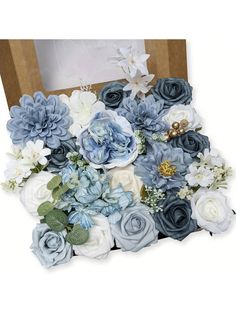 blue and white flowers are arranged in a box