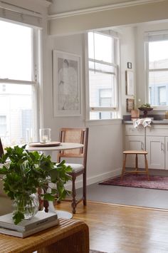 a living room filled with furniture and lots of windows