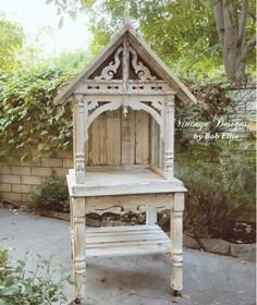 an old wooden bench sitting in the middle of a garden