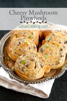 cheesy mushroom pinwheels on a plate with text overlay that reads, cheesy mushroom pinwheels