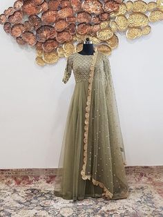 Accentuated with intricate and gleaming pearl, nakshi and sequins embroidery. This super flared double layered net gown has a beautiful sheer net back with embroidery. Duppata is optional.Care:Dry Clean OnlyComposition:Net Embroidery Duppata, Green Anarkali Dress, Net Anarkali, Net Gown, Green Anarkali, Net Gowns, Pearl Work, Early Fall Outfits, Long Frocks