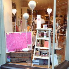 a window display with balloons and other items