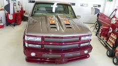 a silver truck parked in a garage next to a red fire extinguisher