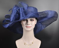 "The oversized brim adorned with a jumbo sinamay bow in and feathers  design characterizes this horse racing event hat made of natural straw. The large brim creates a statement piece, and the sinamay jumbo bow  and netting adds a touch of whimsy and feminine elegance. Crafted from straw, it exudes a light and airy feel, making it a stylish and comfortable choice for a day at the races. The hat combines the classic appeal of a wide brim with the playful charm of a jumbo sinamay bow and netting , Royal Ascot Hats With Feather Trim, Feathered Hat For Royal Ascot Races, Sinamay Costume Hats For Royal Ascot Races, Royal Ascot Race Elegant Hat, Royal Ascot Fedora Costume Hats And Headpieces, Blue Feather Trim Hat For Races, Kentucky Derby Wide Brim Top Hat With Feather Trim, Wide Brim Feathered Hat For Royal Ascot, Chic Feathered Hat For Races