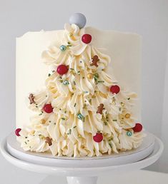 a white cake decorated with icing and decorations