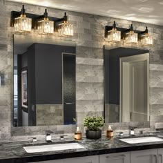 a bathroom with double sinks and two mirrors on the wall above them is decorated in gray marble