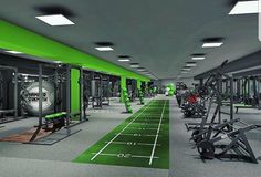 an empty gym with rows of machines and green carpeted flooring is pictured in this image