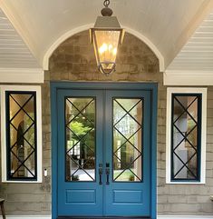 a blue front door with two sidelights