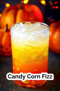 a close up of a drink in a glass with candy corn fizz on it