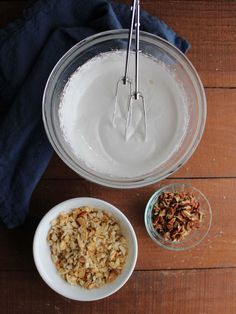 two bowls with oatmeal and spoons next to each other on a wooden table