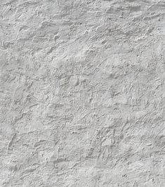 a white stucco wall textured with light gray paint