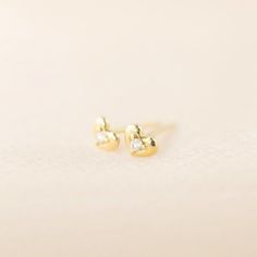 Sweet and petite 14k solid gold heart studs with a single diamond shine in a polish finish. A lightweight yet sturdy piece that is perfect for everyday wear. Simple diamond heart studs to go with any outfit. This earring will make a sweet gift symbolizing feelings of love and appreciation. Purchase this for birthdays, anniversaries or holidays! * Sold as one pair or single stud * Heart width x height: ≈5mm x ≈4mm * Diamond weight: ≈0.03ct (0.015ct for single stud) * Earring post: 10mm long * Clo Yellow Gold Heart Earrings For Anniversary, Tiny Dainty Yellow Gold Heart Earrings, Dainty Tiny Yellow Gold Heart Earrings, Dainty 14k White Gold Heart Earrings, Elegant Small Yellow Gold Heart Earrings, Gold Diamond Heart Earrings In Dainty Style, Dainty Diamond Heart Earrings In Gold, Dainty Gold Diamond Heart Earrings, Tiny Diamond Earrings