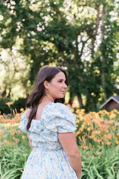 Warm days aren’t complete until you stroll in the Verona Dress. This dress features a beautiful blend of pastel blues and yellows to elevate your style and spirits. Statement sleeves and a full-length skirt add irresistible charm to your look, while the elastic waistline provides generous stretch and all-day comfort. This dress is perfect for soon-to-be mothers with bump-friendly ensembles. STYLE INFO & CARE The smocked bodice for a flexible, comfortable fit Skirt lined 100% polyester Maternity Light Blue Square Neck Dress For Garden Party, Light Blue Puff Sleeve Dress For Garden Party, Spring Light Blue Maxi Dress For Garden Party, Blue Cottagecore Dress For Spring, Light Blue Maxi Dress For Garden Party In Spring, Light Blue Maxi Dress For Spring Garden Party, Blue Cottagecore Dress With Puff Sleeves, Blue Midi Dress With Smocked Back For Garden Party, Light Blue Smocked Dress For Day Out