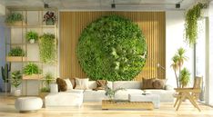 a living room with plants on the wall and white couches in front of it