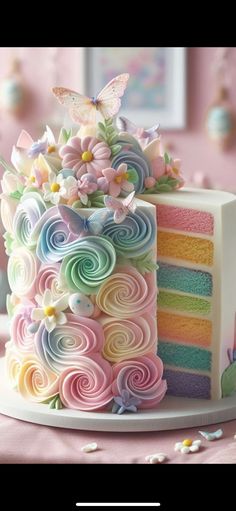 a multi - colored cake with swirls and butterflies on top is shown in this image