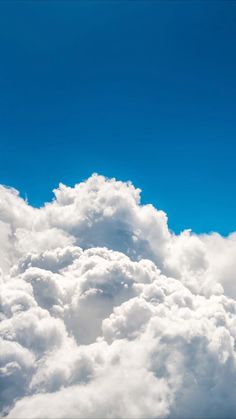 the airplane is flying high above the clouds