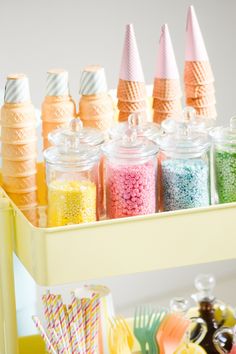 there are many different colored candy in the jars