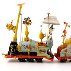 two figurines are sitting on top of a toy train