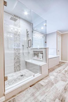 a bathroom with a walk in shower next to a bathtub and sink under a mirror