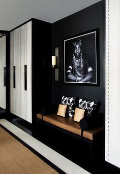 a black and white living room with an art work on the wall next to it