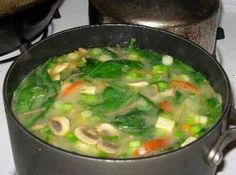 a pot filled with soup sitting on top of a stove