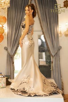 a woman in a wedding dress standing on a table next to a cake and balloons