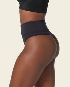 This shaper thong panty is the perfect combo between compression and coverage. Moderate compression in the mid-to-lower tummy shapes your silhouette comfortably. Made of our super soft seamless SkinFuse® fabric for a second skin feel. Its double-layered waistband and flexible boning keep it in place and accentuate your curves. Compressive Shapewear Brief With Built-in Bra, Compressive Shapewear Bottoms With Built-in Bra, Compression Shapewear With Built-in Bra And High-cut Leg, High-cut Leg Compression Shapewear, Compressive High-cut Leg Shapewear With Seamless Construction, Seamless Compression Shapewear, Compression Seamless Shapewear For Workout, Seamless Compression Shapewear For Workout, Solid Compression Brief Shapewear