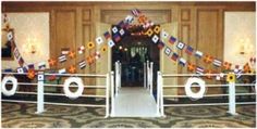 an entrance to a building with flags on the railings and carpeted flooring