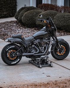 a black motorcycle parked on top of a sidewalk