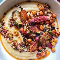 a white bowl filled with food on top of a table