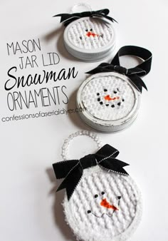 two snowman ornaments with black bows are shown on a white background and the words mason jar lid, snowman ornaments